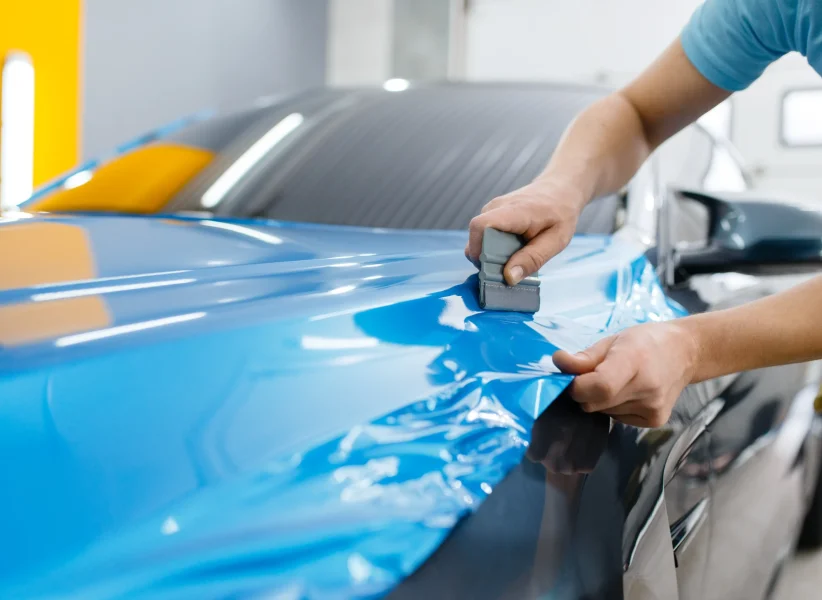 car-wrapping-mechanic-with-squeegee-installs-film-2024-12-05-05-19-40-utc